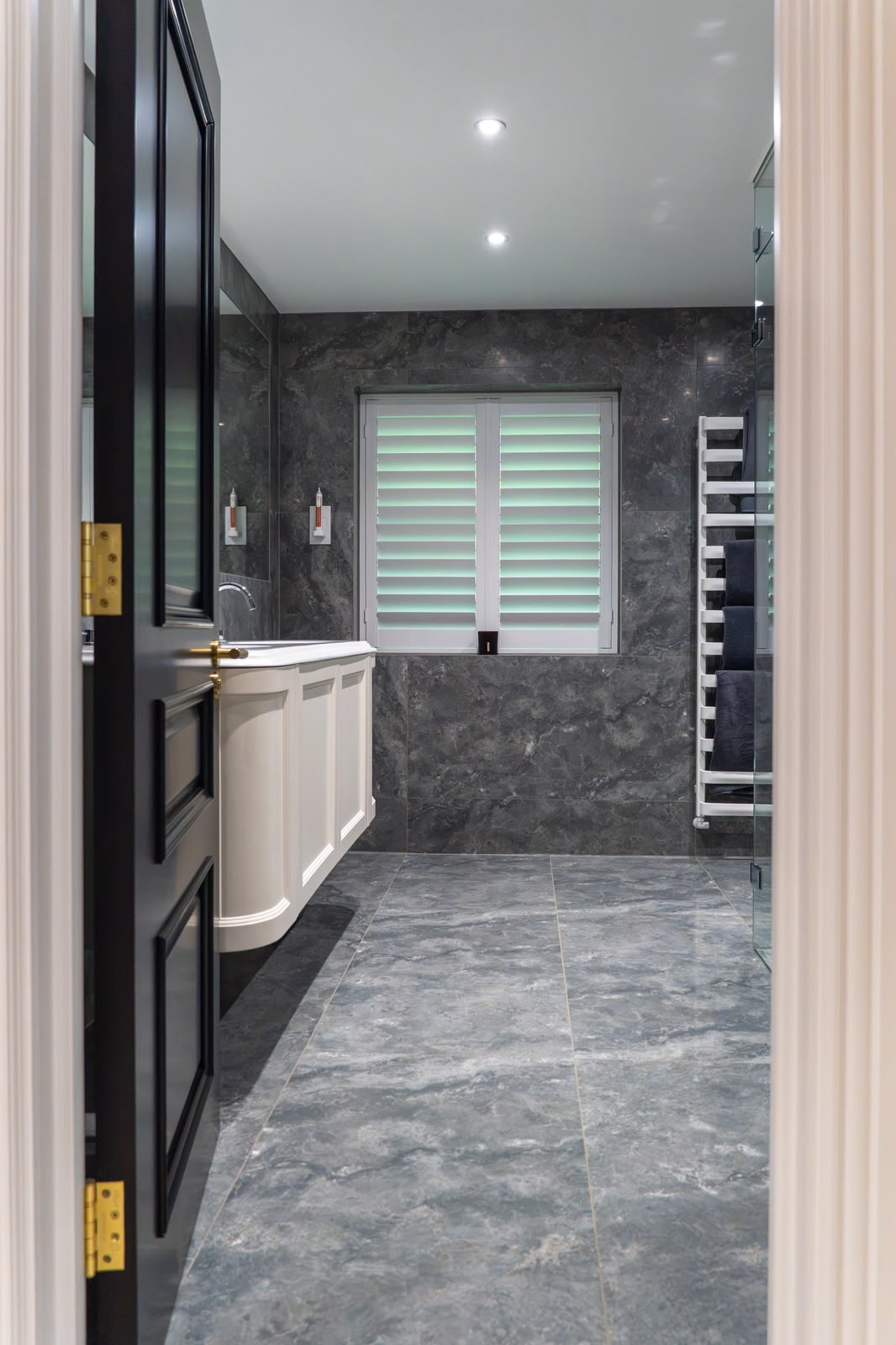 Grey marble-effect bathroom wall and floor tiling in South East London