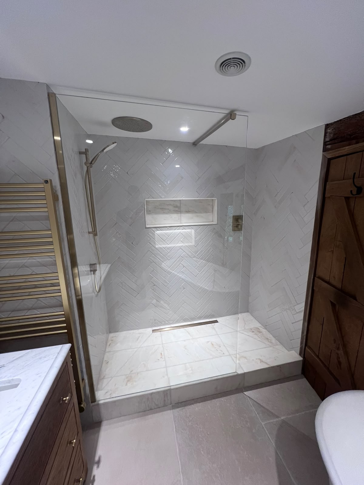 Herringbone tiled walk-in shower in a Kent bathroom