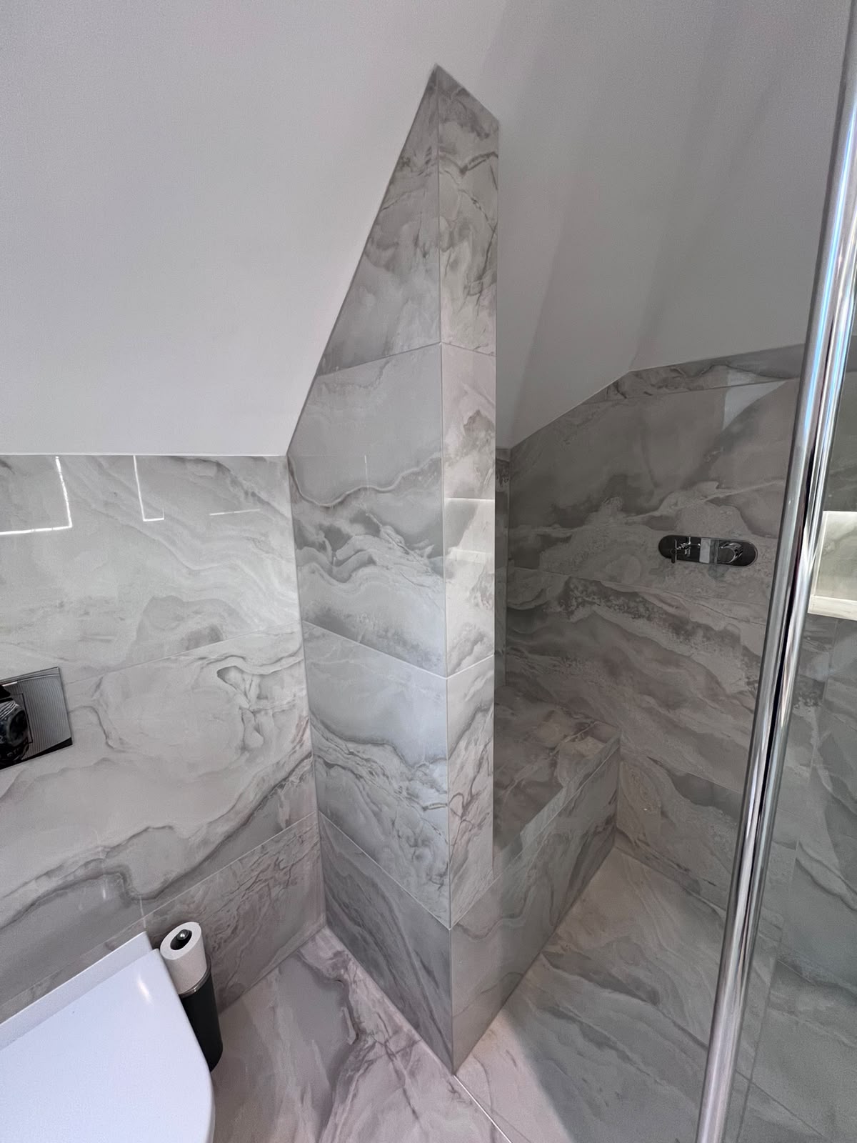 Mitred edge tiling to a tiled shower column in Kent