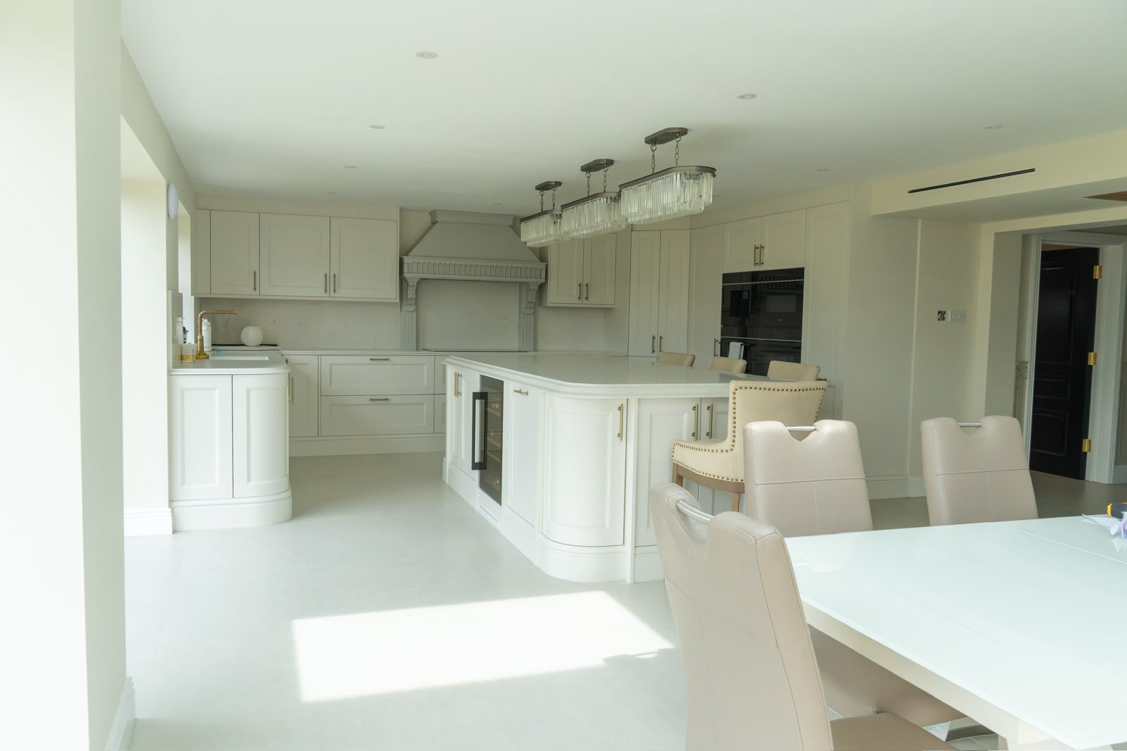 Kitchen floor tiling in Kent with large-format pale porcelain tiles