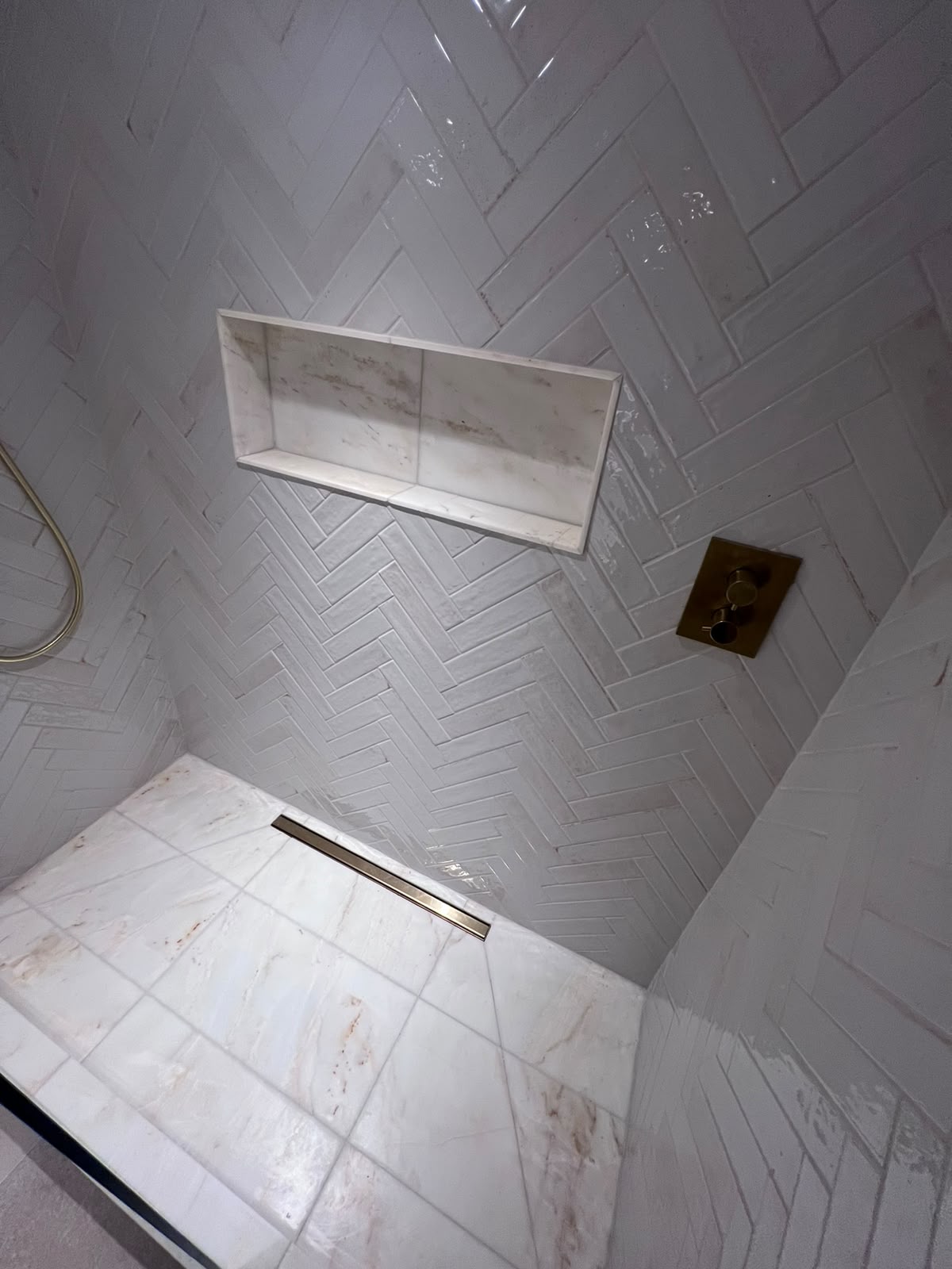 Herringbone wall tiling in a Kent shower with recessed niche, serving Westerham