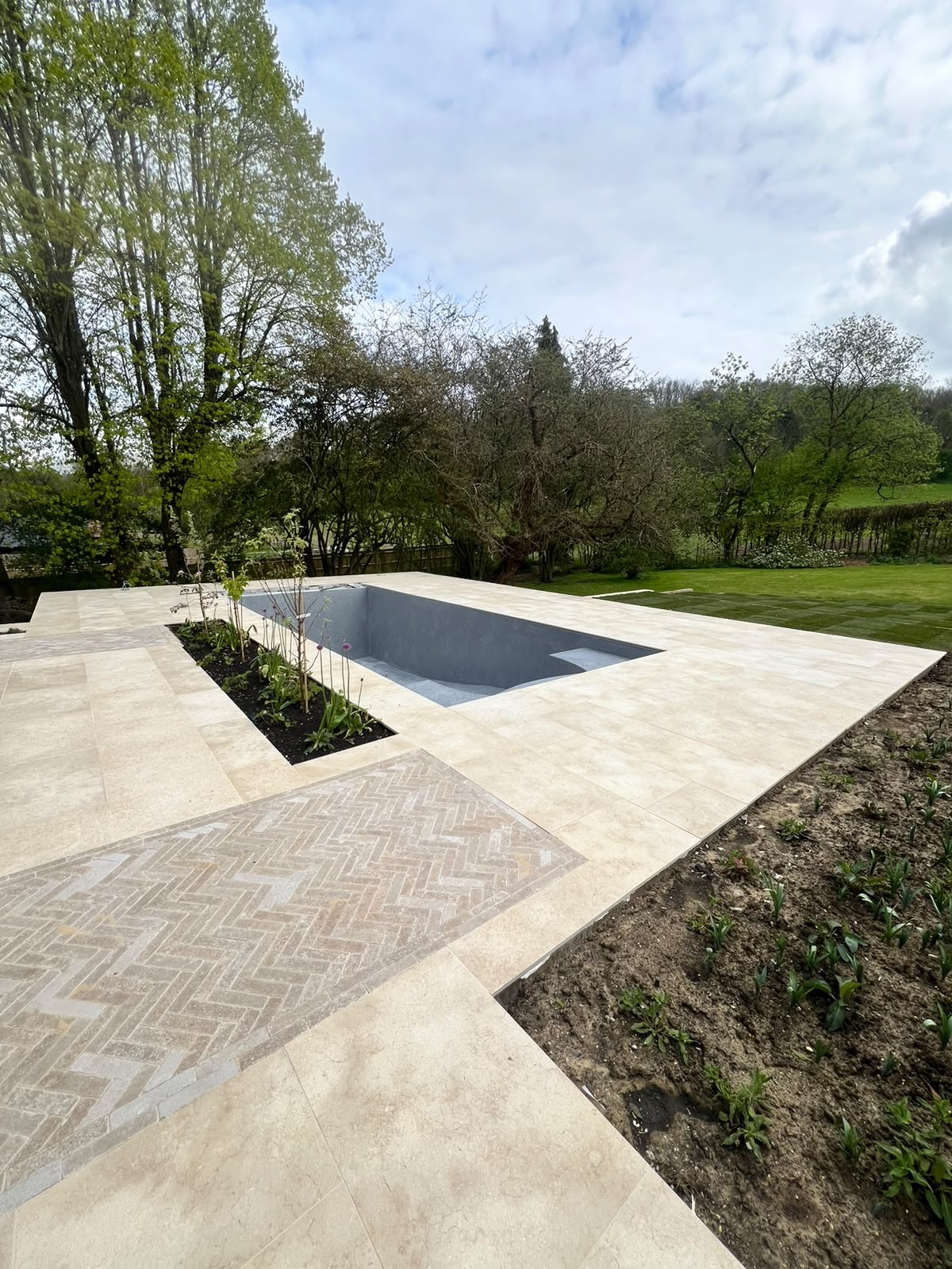 Limestone pool terrace tiling with herringbone stone inset in Kent