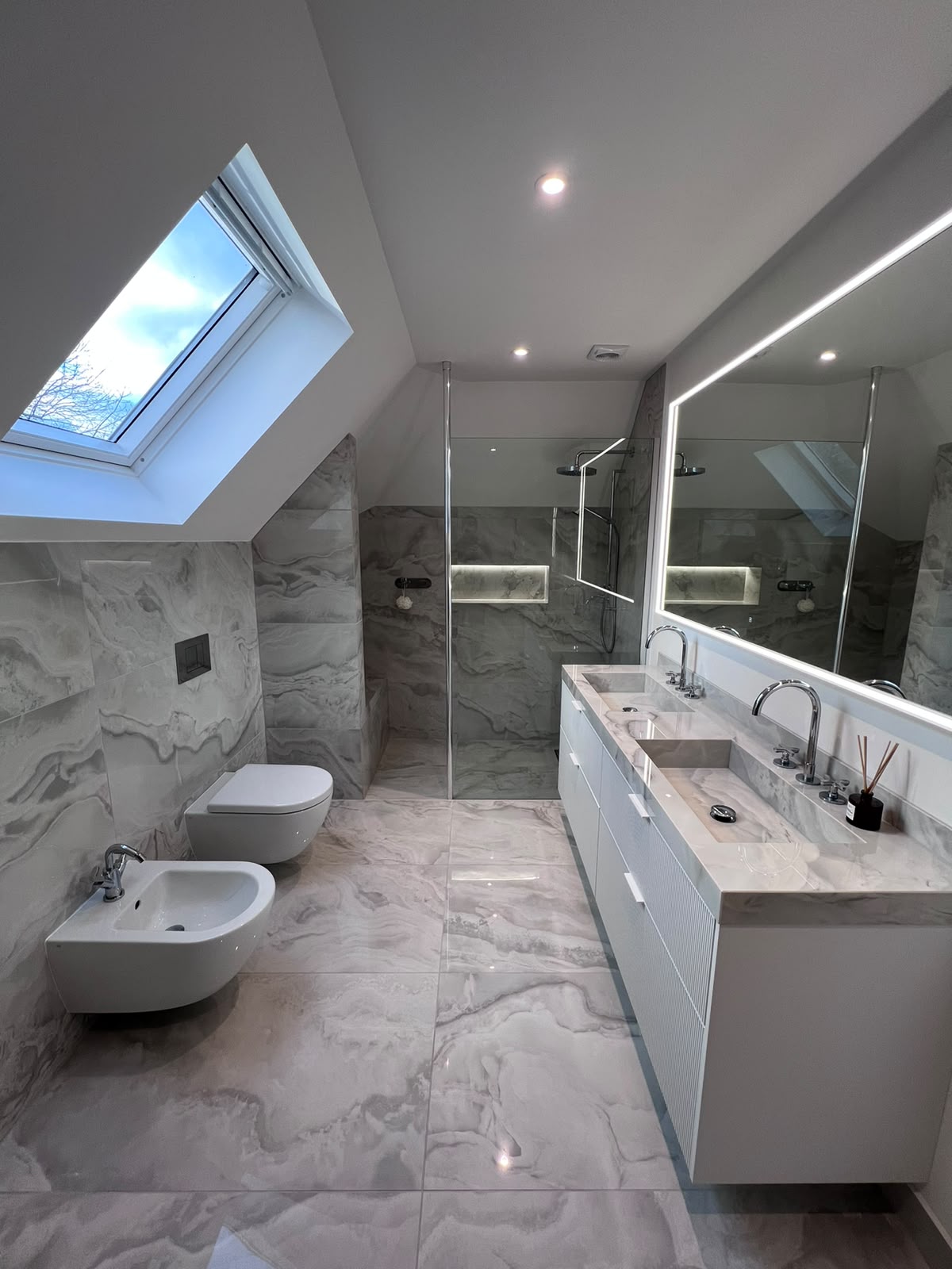 Bathroom refurbishment in Kent with marble-effect tiling, walk-in shower and twin basins